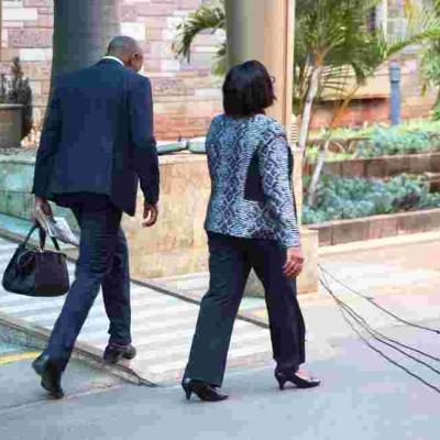 Kenyans Online React to Photo of Gender CS Sicily Kariuki's Bodyguard Carrying Her Handbag