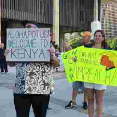 Protesters Carrying "Welcome to Kenya" Placards Welcome President Donald Trump in Hawaii