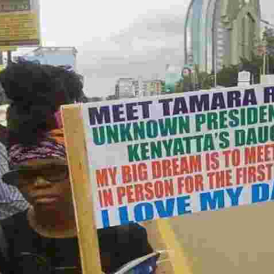 Photo of a Placard Carrying Woman Claiming to be President Uhuru's 'Uknown' Daughter Goes Viral Online