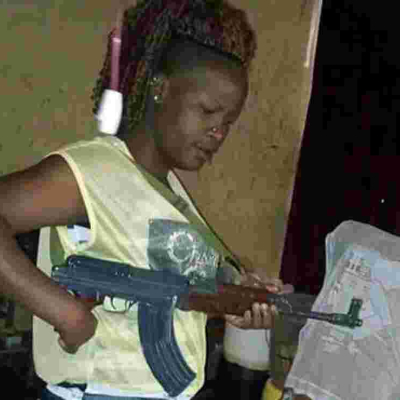 Photos of Gun-Wielding Kenyan Woman Go Viral Online, Kenyans Call for Her Arrest